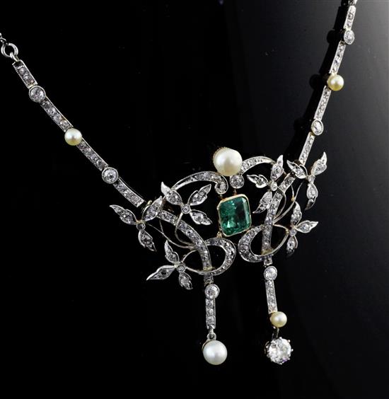 An Edwardian platinum and 18ct gold, emerald, diamond and pearl drop necklace, central motif 2in.